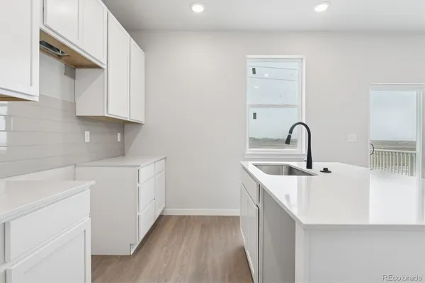 a kitchen with a sink and cabinets