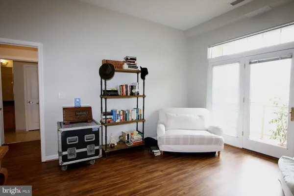 a bedroom with furniture and wooden floor