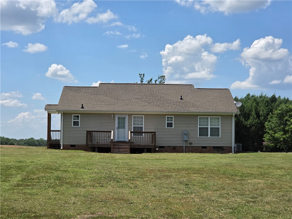 325 McAdams School Road Honea Path, SC 29654 - Photo 5 of 22 A classic rural home features a welcoming back deck overlooking an expansive grassy field.