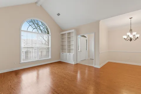 a view of an empty room and wooden floor
