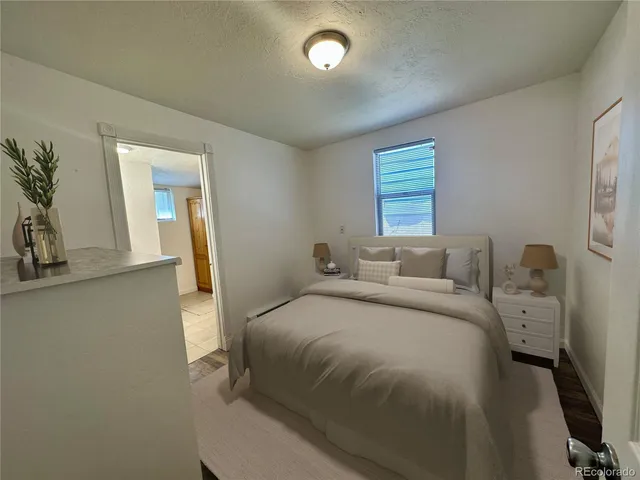 a bedroom with a bed and a potted plant