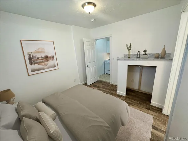 a bedroom with a bed and a view of kitchen