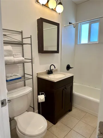 a bathroom with a sink vanity mirror and toilet