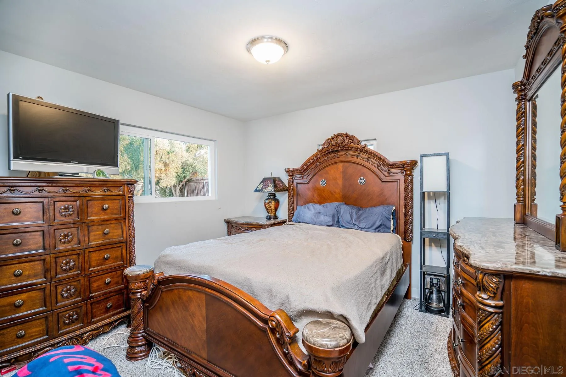 9206 Lamar Street Spring Valley, CA 91977 - Photo 13 of 21 a bedroom with a bed and a flat screen tv