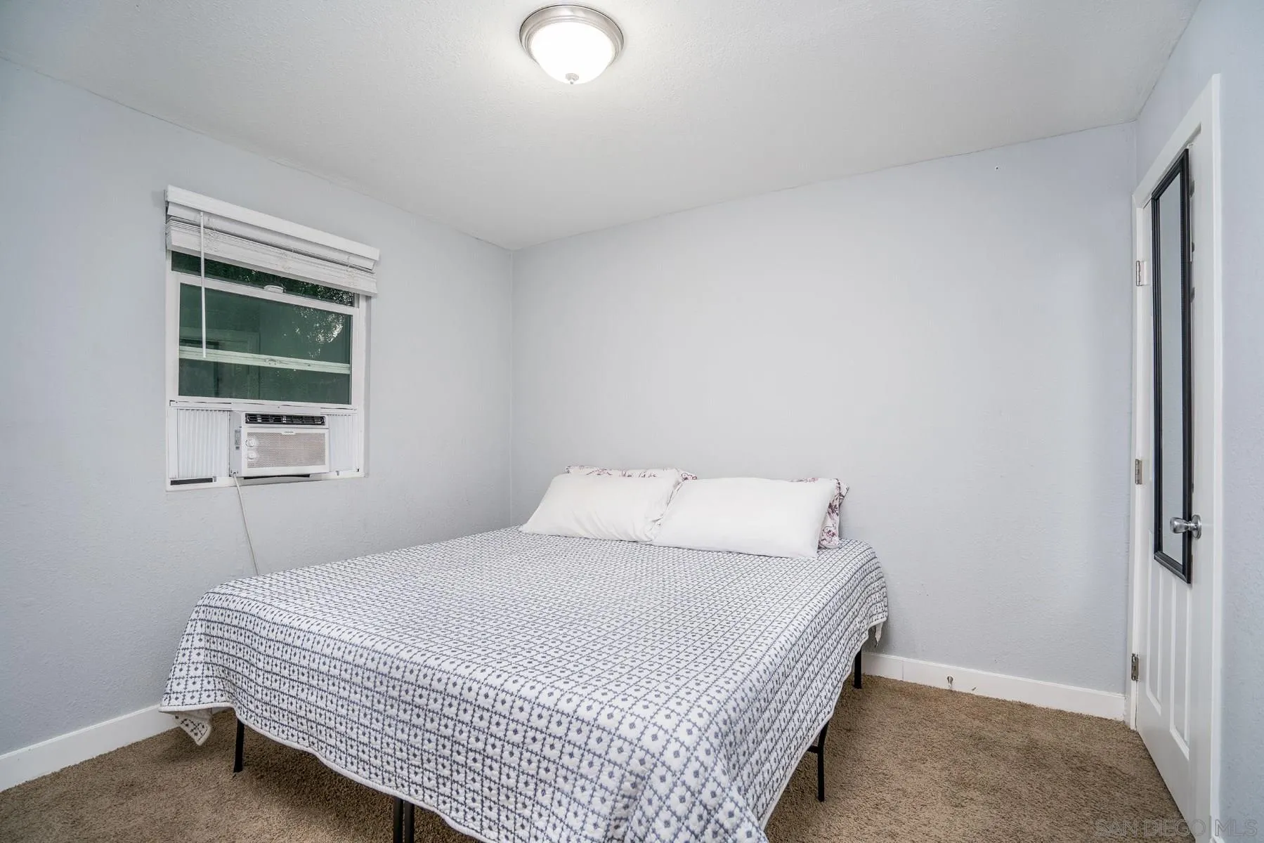 9206 Lamar Street Spring Valley, CA 91977 - Photo 21 of 21 a bedroom with a bed and a window