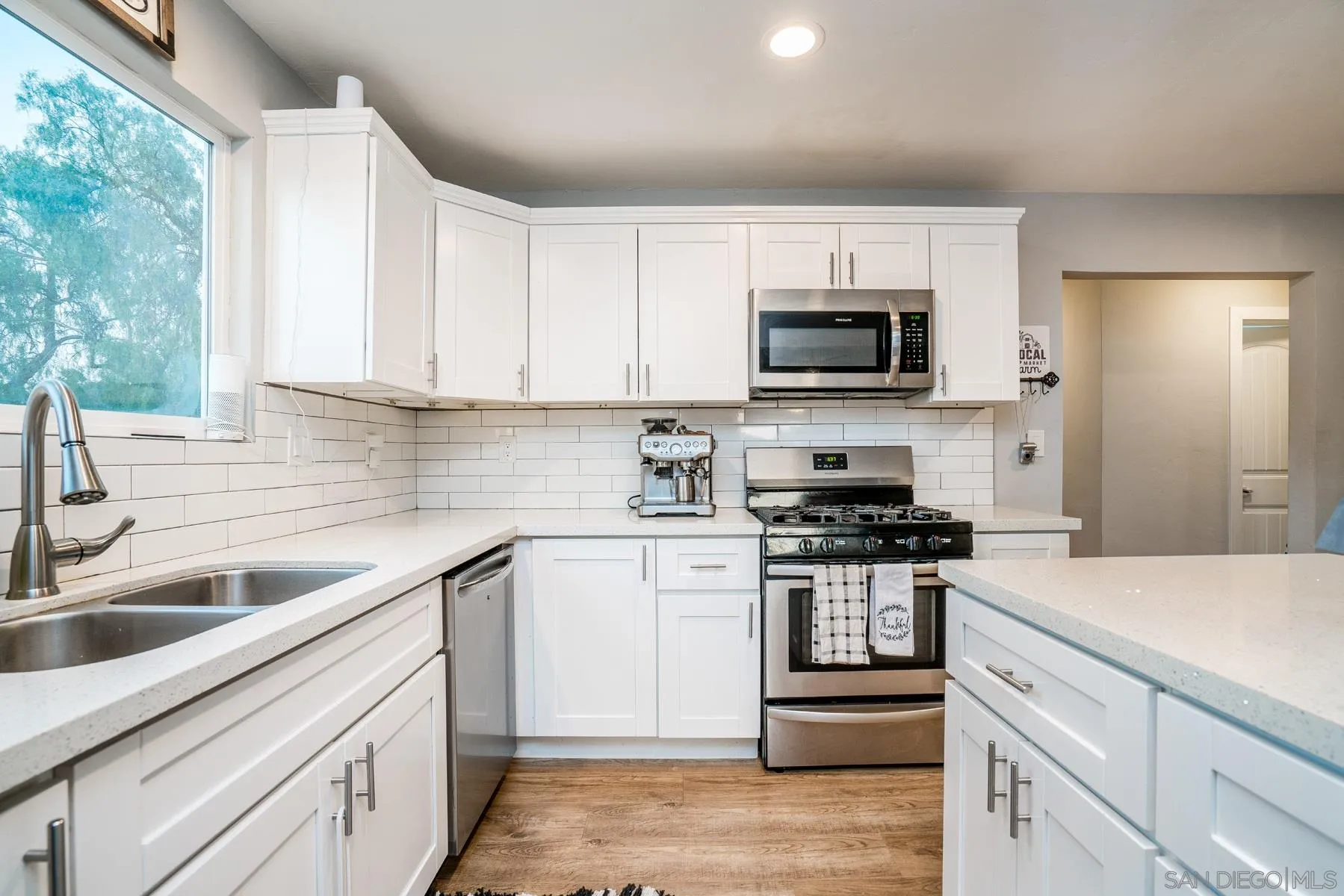 9206 Lamar Street Spring Valley, CA 91977 - Photo 4 of 21 a kitchen with stainless steel appliances granite countertop a sink and a stove