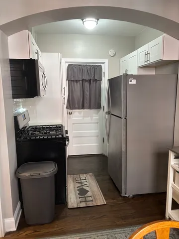 a kitchen with a refrigerator cabinet and a fireplace