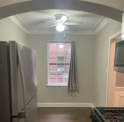 a view of a livingroom with a ceiling fan and window
