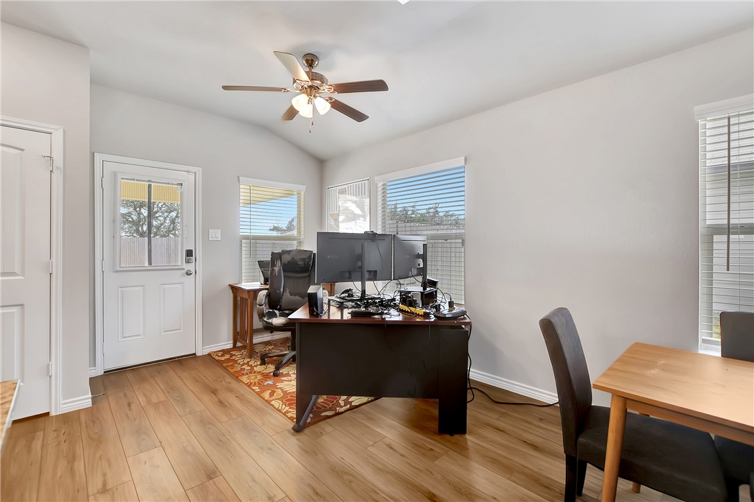 909 Davy Street Brenham, TX 77833 - Photo 15 of 35 Area featuring light wood-type flooring, a ceiling fan, vaulted ceiling, and plenty of natural light