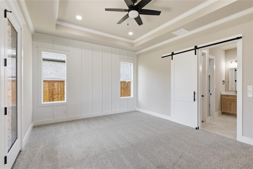709 Anne Road Van Alstyne, TX 75495 - Photo 18 of 28 Spacious room featuring light gray carpeting and a tray ceiling with recessed lighting