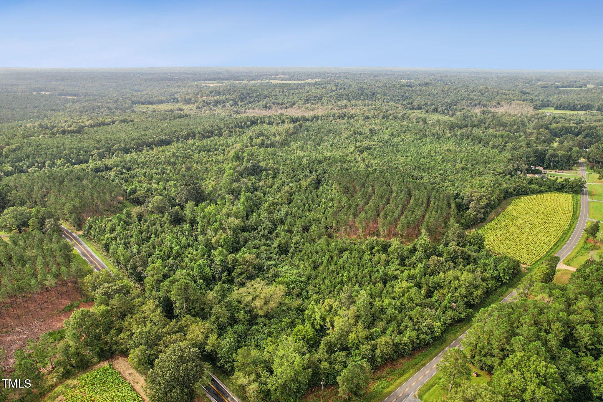 an aerial view of a houses with a yard