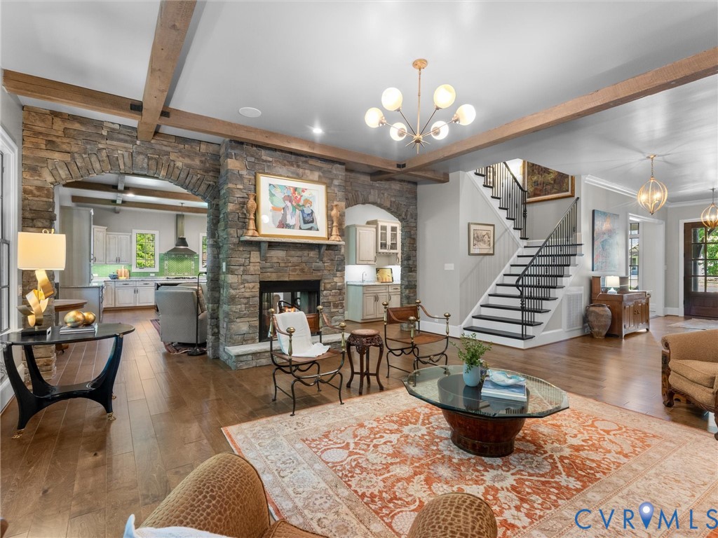 16131 Binley Road Midlothian, VA 23112 - Photo 24 of 99 a living room with furniture a fireplace and a chandelier