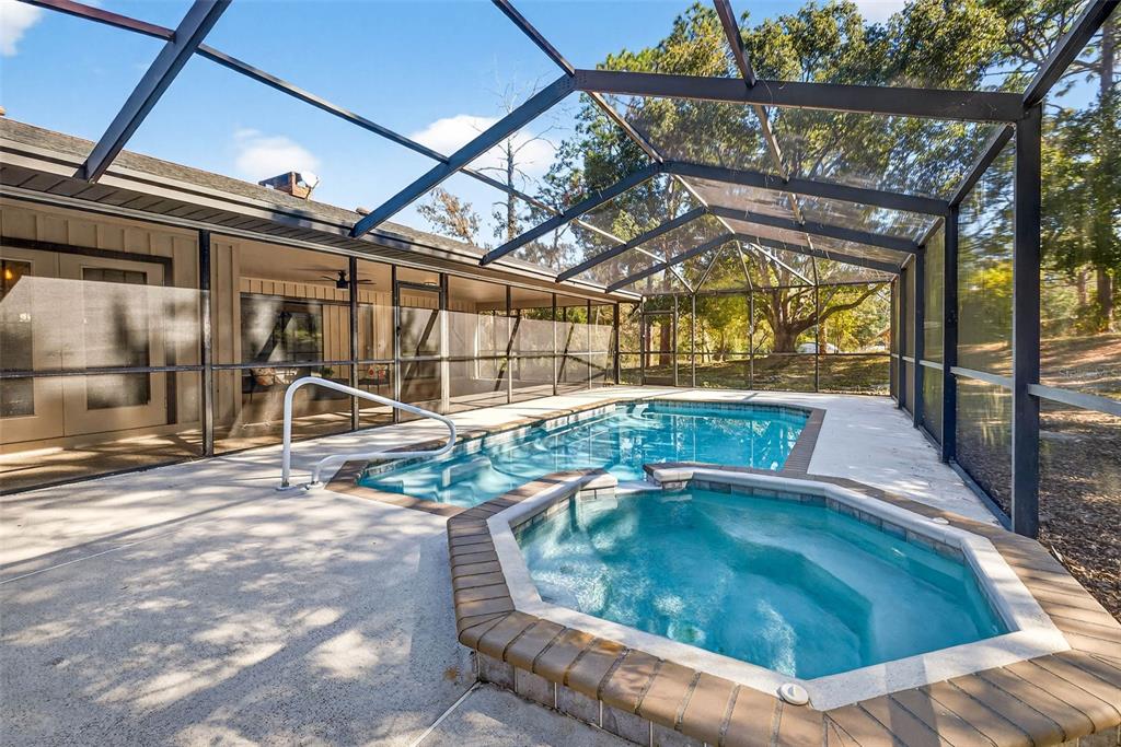 14252 Trinity Road Brooksville, FL 34614 - Photo 17 of 26 a view of a swimming pool with a patio