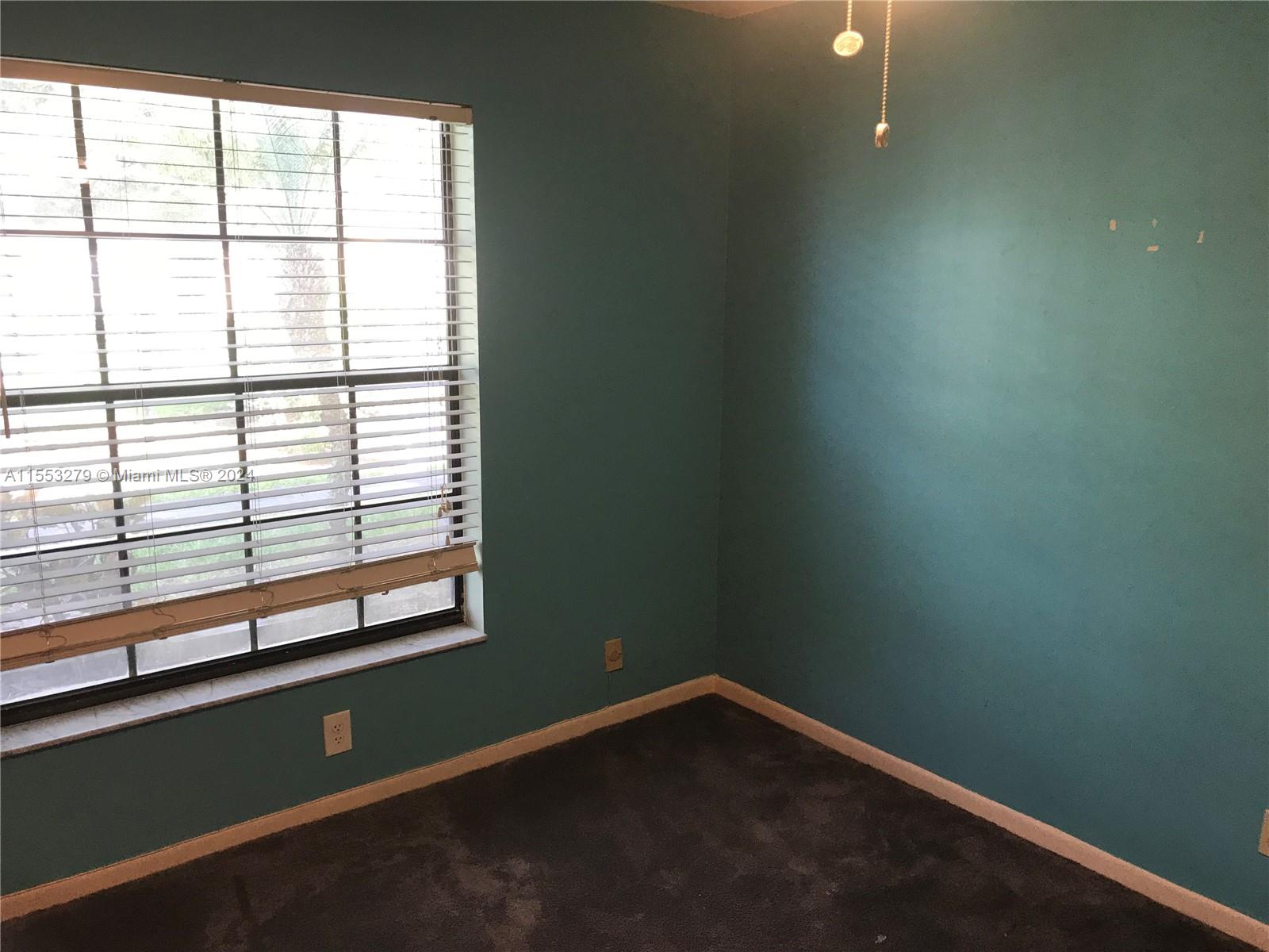 7512 Southwest 26th Court, Unit 12 Davie, FL 33314 - Photo 23 of 30 a view of a room that has a window