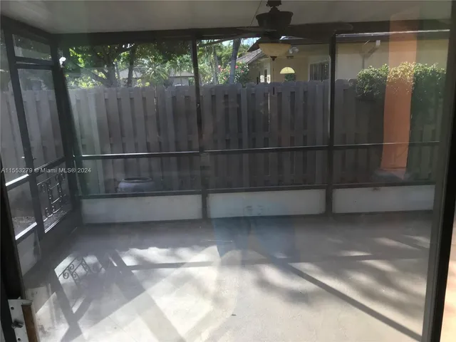 a view of backyard with wooden floor and window