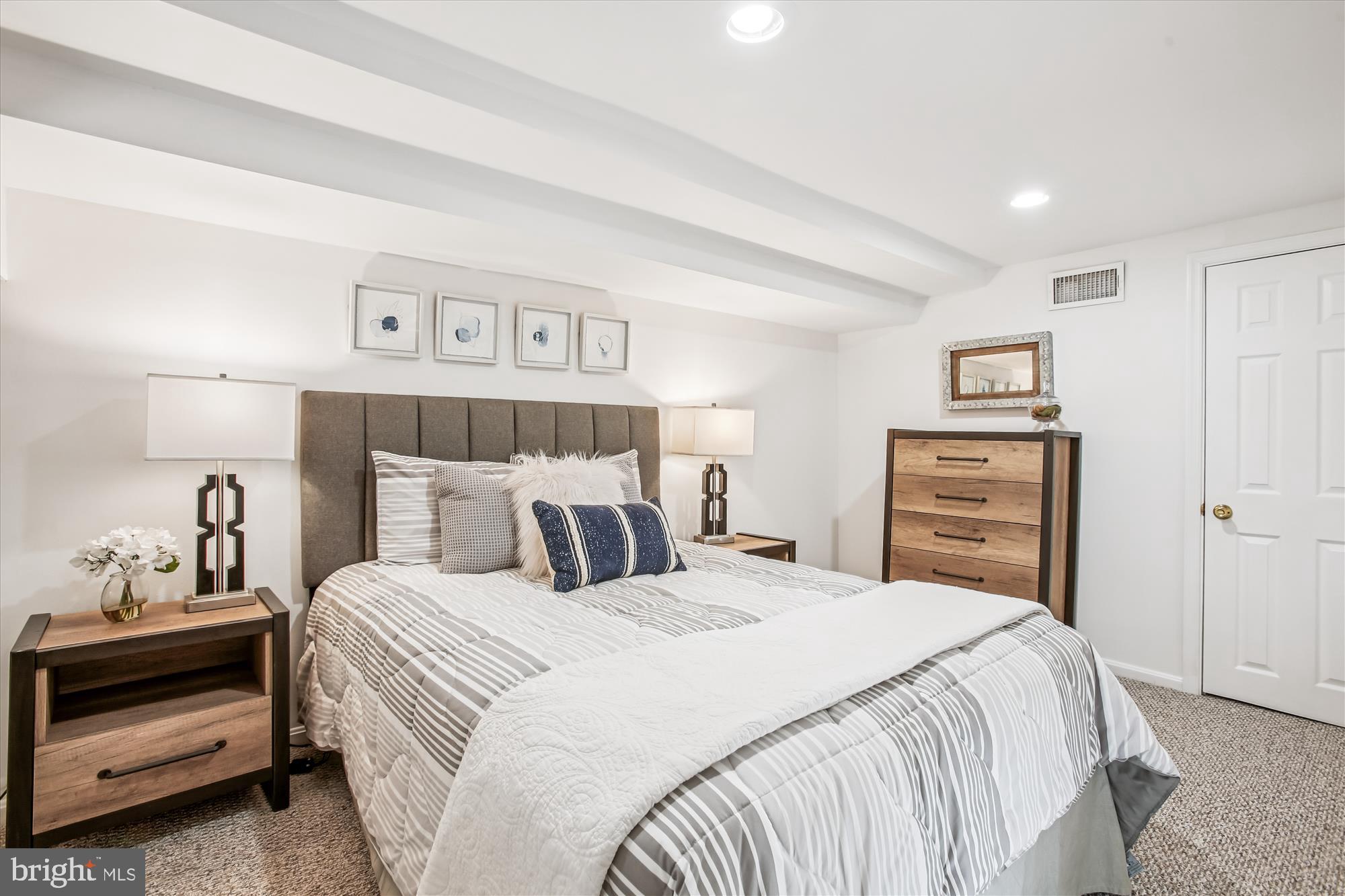 1760 E Street Northeast Washington, DC 20002 - Photo 27 of 46 a bedroom with a bed a dresser and a mirror