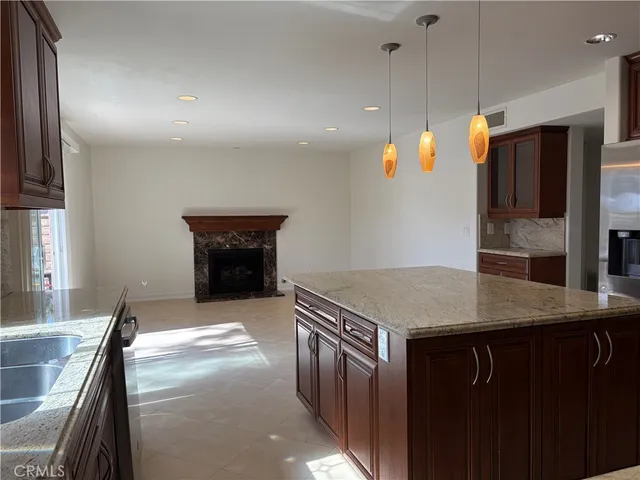 a kitchen with stainless steel appliances granite countertop a refrigerator and a stove