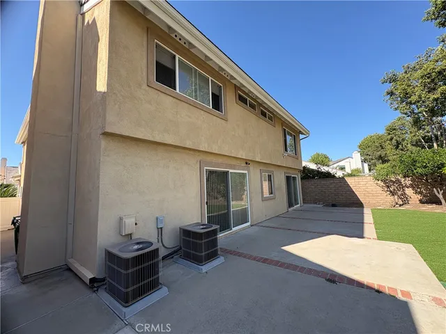 an aerial view of a house with a garden and lake view