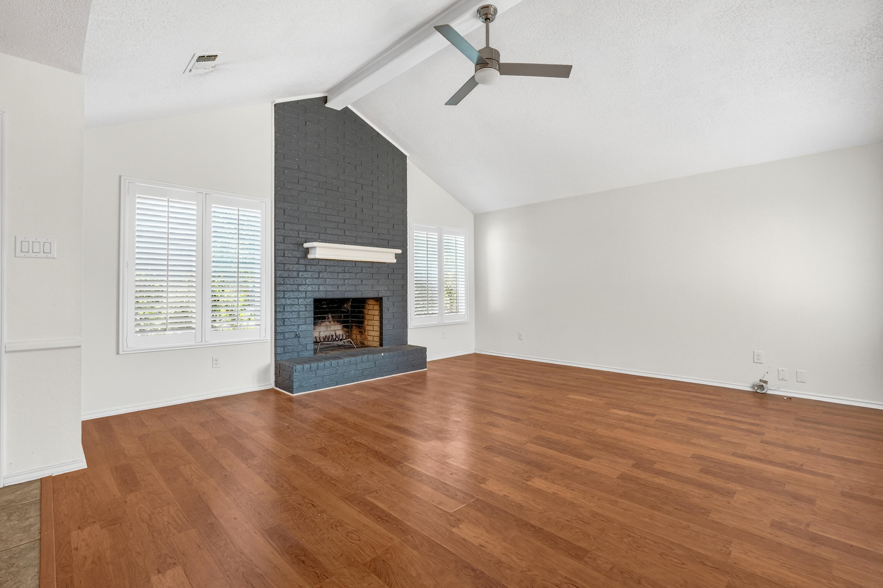 5221 84th Street Lubbock, TX 79424 - Photo 4 of 26 a view of empty room with fireplace and wooden floor