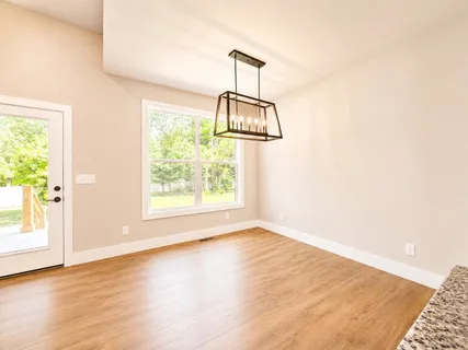 a view of a kitchen with a sink and wooden floor
