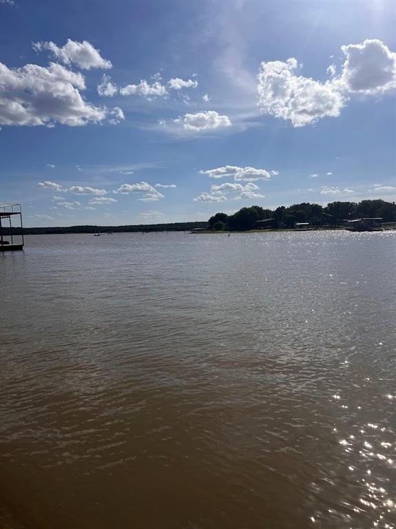 927 Cutter Circle May, TX 76857 - Photo 23 of 23 Expansive waterfront setting featuring a tranquil body of water, distant tree-lined shore, and a multi-level boat dock