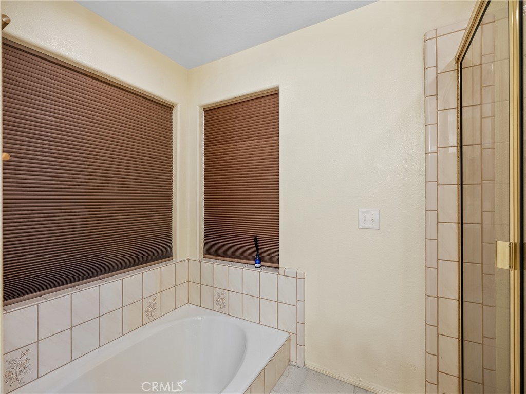 18668 Kamana Road Apple Valley, CA 92307 - Photo 26 of 35 Primary bathroom with tub and walk in shower