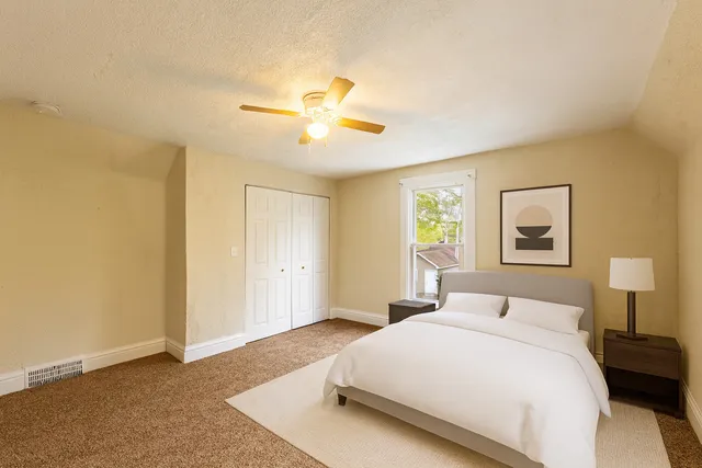a bedroom with a bed and a chandelier