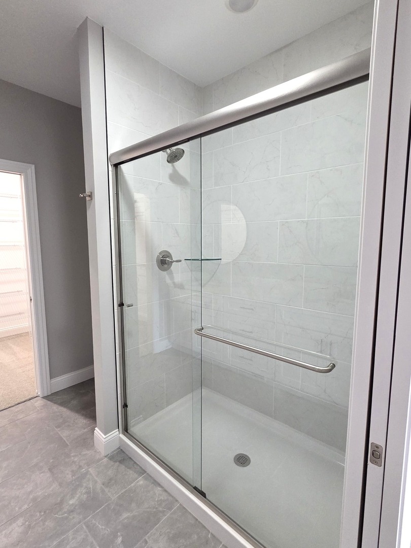 3 Saint Ivans Circle Bloomington, IL 61705 - Photo 14 of 29 a bathroom with a glass shower door