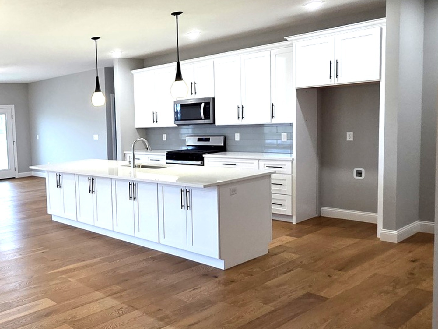 3 Saint Ivans Circle Bloomington, IL 61705 - Photo 20 of 29 a kitchen with stainless steel appliances kitchen island granite countertop a sink a stove and a refrigerator