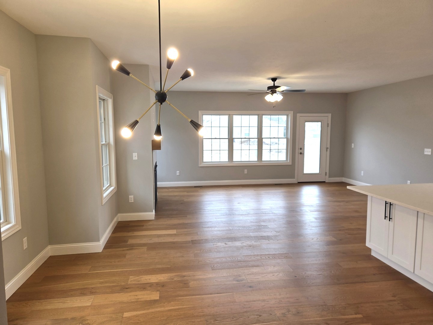 3 Saint Ivans Circle Bloomington, IL 61705 - Photo 8 of 29 a view of an empty room with wooden floor and a window