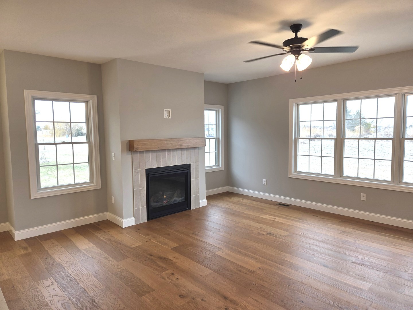 3 Saint Ivans Circle Bloomington, IL 61705 - Photo 9 of 29 wooden floor fireplace and windows in an empty room