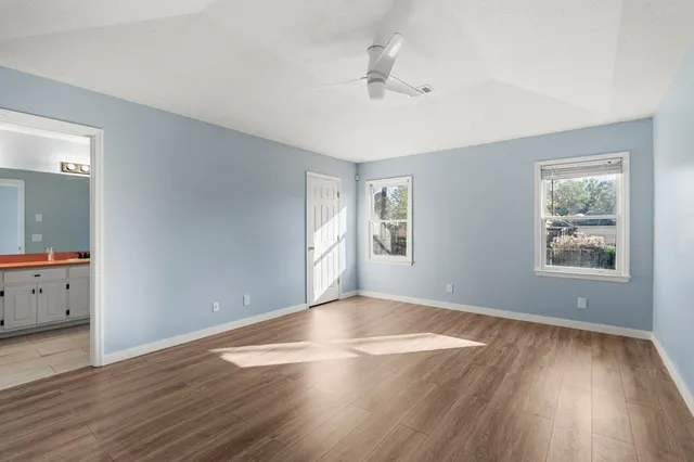 wooden floor in an empty room with a window