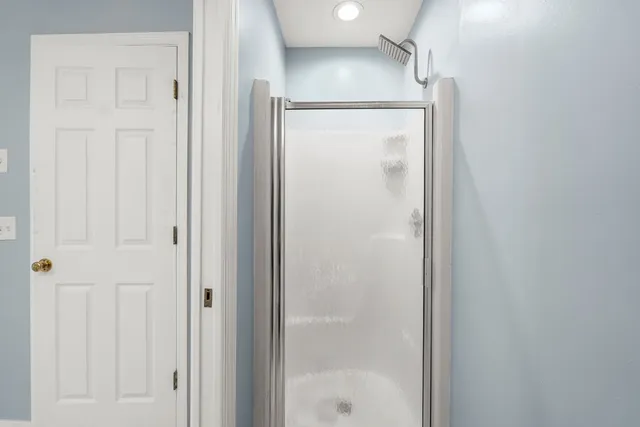 a bathroom with a glass shower door