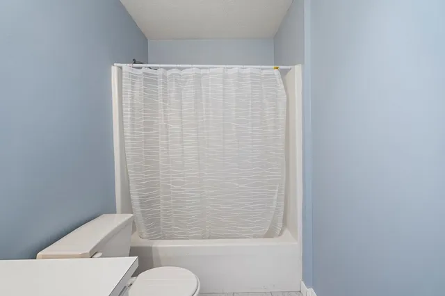 a bathroom with a shower curtain