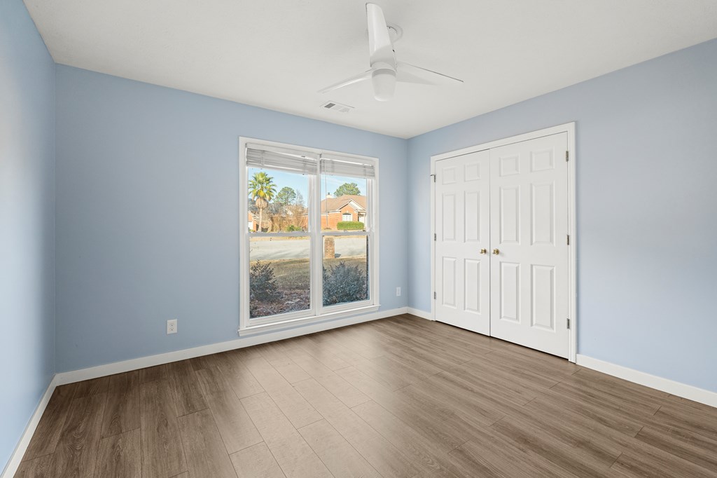 4824 Spring Ridge Court Columbus, GA 31909 - Photo 20 of 28 a view of an empty room with wooden floor and a window