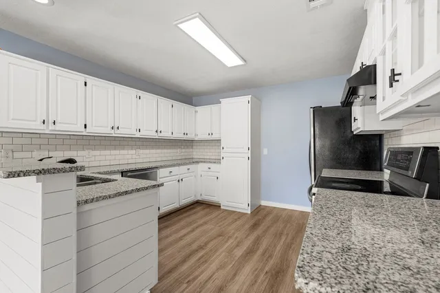 a kitchen with a sink stove and refrigerator