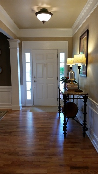 5435 Brandy Bay Road Raleigh, NC 27613 - Photo 8 of 25 Transom windows around the front entry, wainscoting, pillar, custom crown molding Foyer