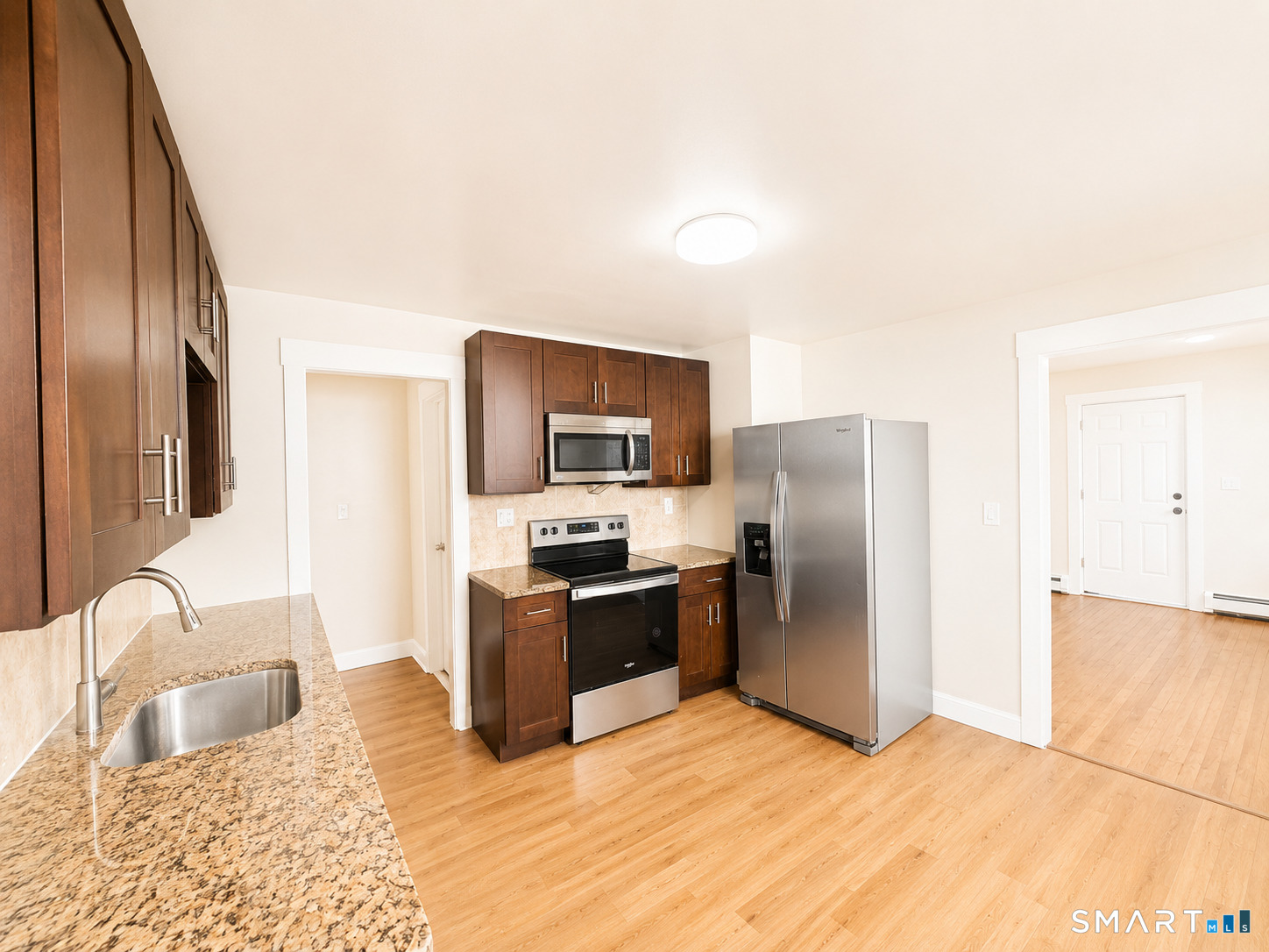 52 Beech Street, Unit 54 Bristol, CT 06010 - Photo 1 of 1 a kitchen with stainless steel appliances granite countertop a refrigerator a stove top oven a sink and dishwasher