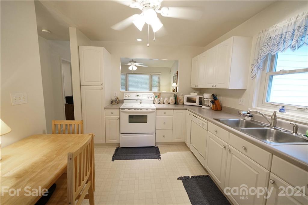 2975 Sharon Road York, SC 29745 - Photo 5 of 18 a kitchen with a sink white cabinets and white appliances