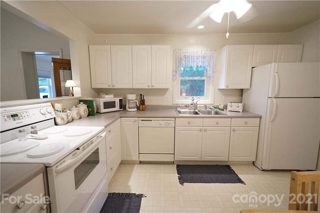2975 Sharon Road York, SC 29745 - Photo 6 of 18 a kitchen with white cabinets and white appliances