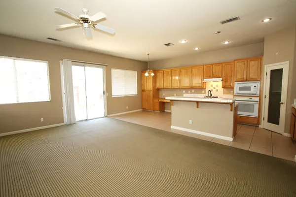 a view of a kitchen with a sink a refrigerator and a window
