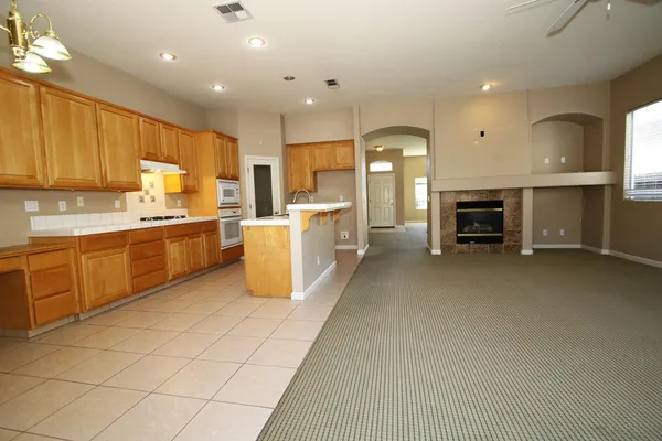 a open kitchen with cabinets a sink and appliances