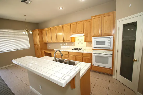 a kitchen with a sink a stove a refrigerator a washer dryer and dining table
