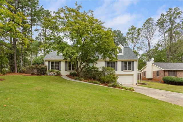 a front view of a house with garden