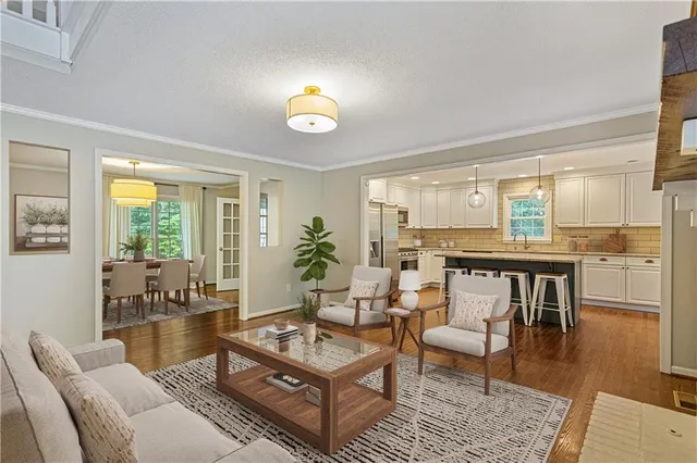 a living room with furniture and wooden floor