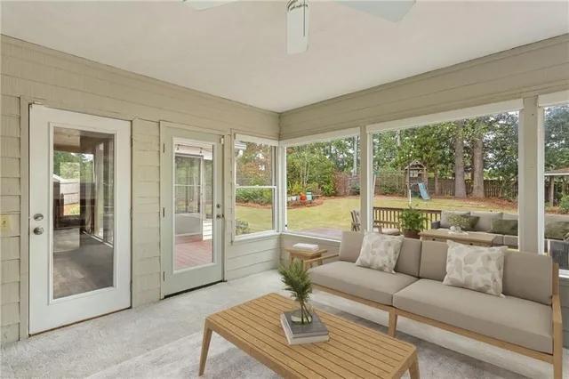 a living room with furniture and a floor to ceiling window