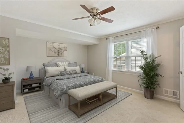 a bedroom with a bed and a potted plant