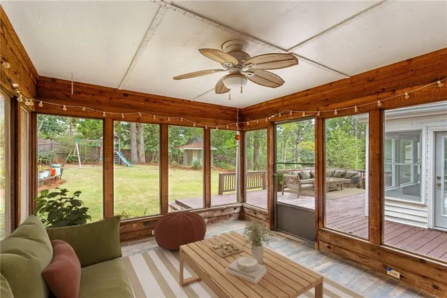 a view of a patio with dining table and chairs with wooden floor