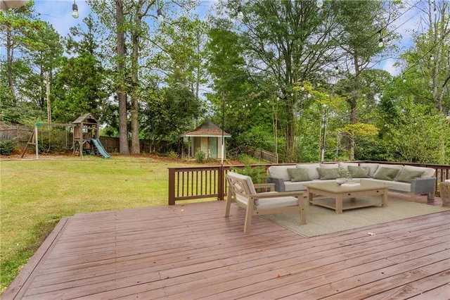 a view of a house with backyard and sitting area