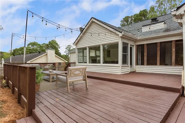 a backyard of a house with plants and large trees